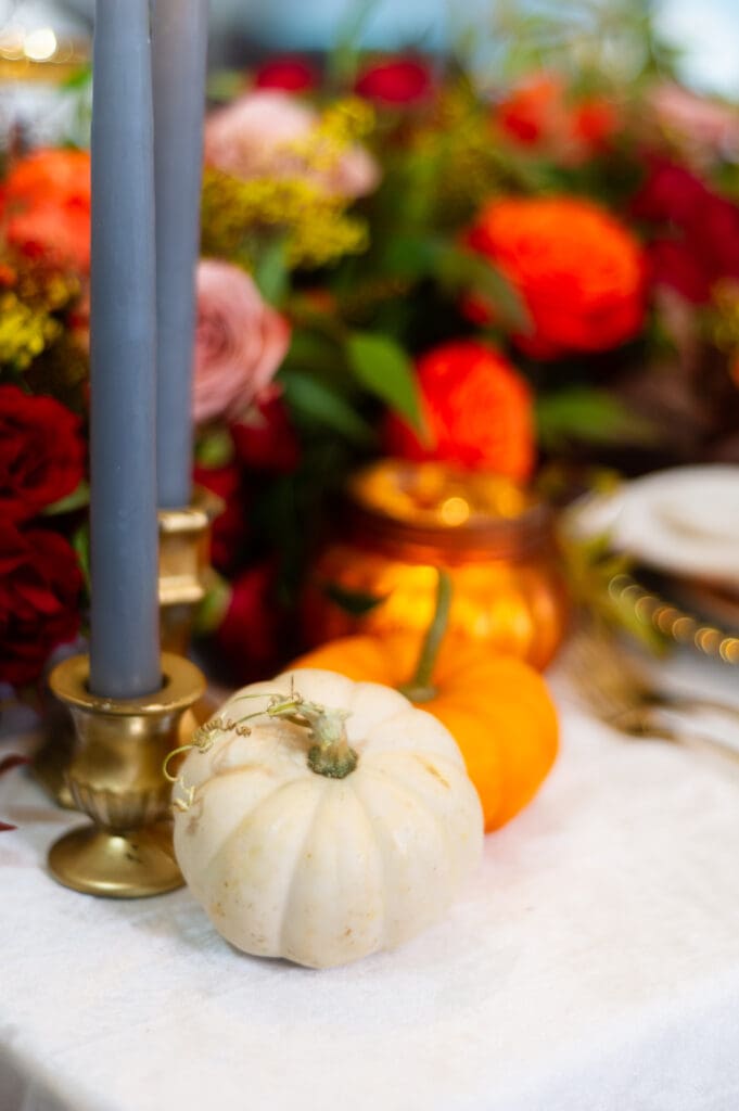 Elegant fall event décor featuring burgundy florals, candlelit tables, and sophisticated autumn styling by an Orlando event planner