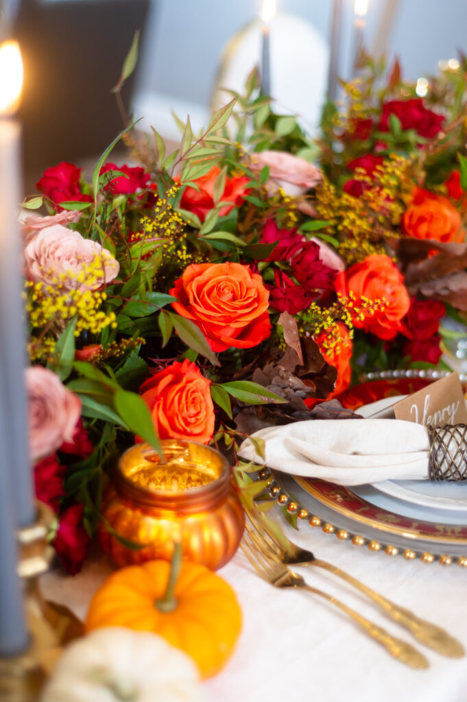 Elegant fall event décor featuring burgundy florals, candlelit tables, and sophisticated autumn styling by an Orlando event planner
