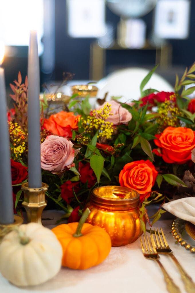Elegant fall event décor featuring burgundy florals, candlelit tables, and sophisticated autumn styling by an Orlando event planner
