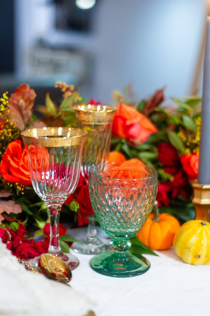 Elegant fall event décor featuring burgundy florals, candlelit tables, and sophisticated autumn styling by an Orlando event planner