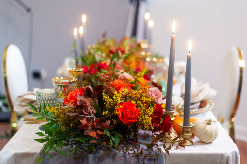 Elegant fall event décor featuring burgundy florals, candlelit tables, and sophisticated autumn styling by an Orlando event planner