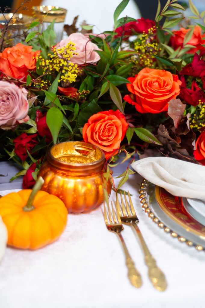 Elegant fall event décor featuring burgundy florals, candlelit tables, and sophisticated autumn styling by an Orlando event planner