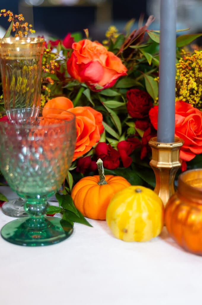 Elegant fall event décor featuring burgundy florals, candlelit tables, and sophisticated autumn styling by an Orlando event planner